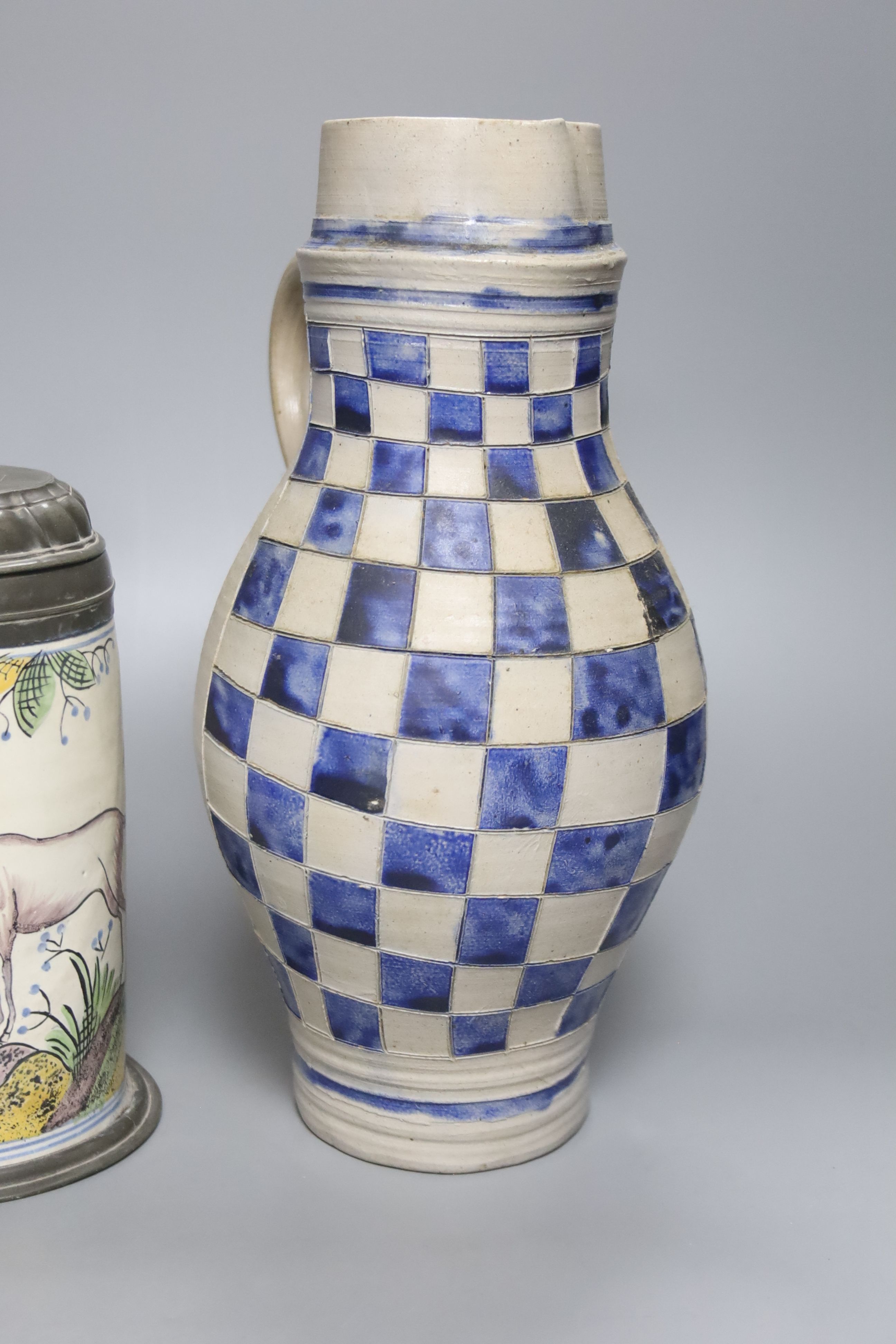 An 18th/19th century German faience pewter-mounted stein decorated with a stag and a German stoneware pitcher, height 25cm & 30cm